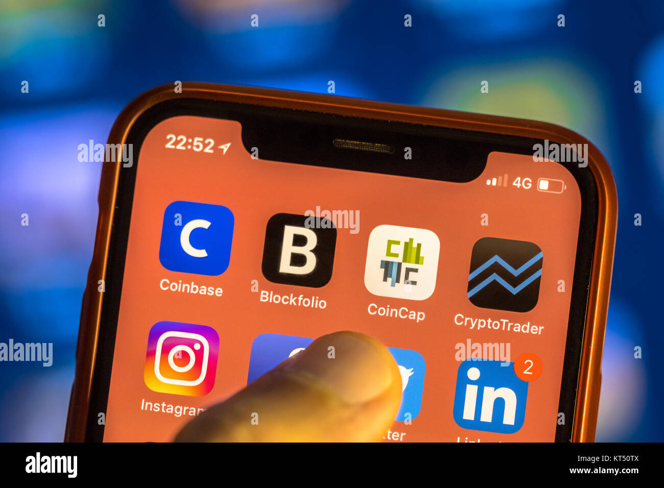 NEW YORK, USA - NOVEMBER 7, 2017: Crypto currency app icons on new smartphone display close-up around other social media iphone applications Stock Photo