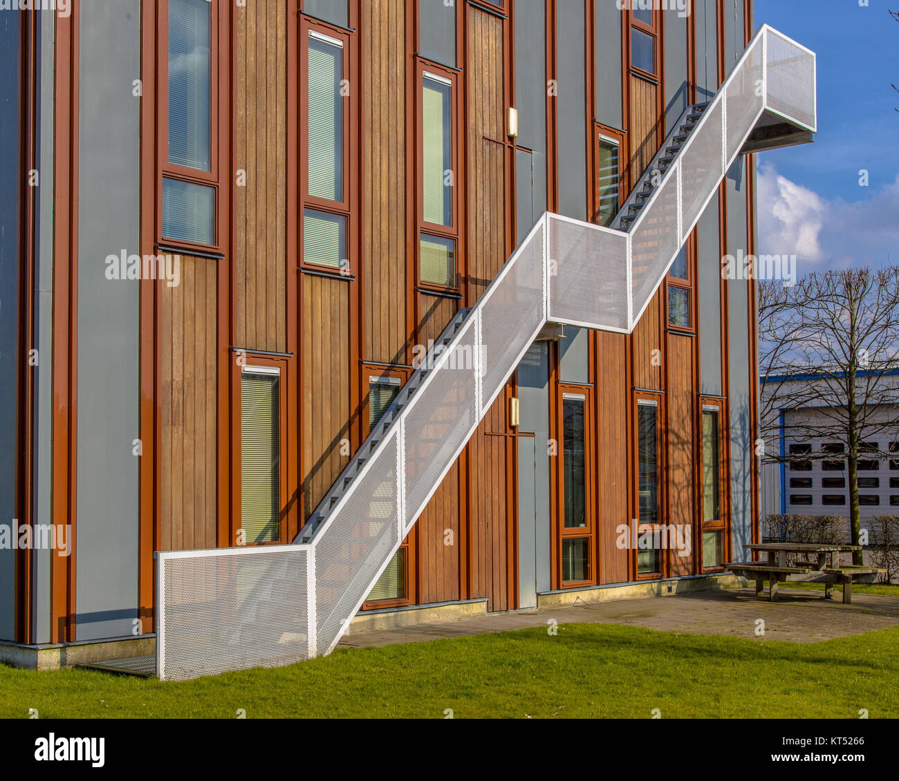 Wooden facade of sustainable office building with emergency exit escape ladder on the exterior Stock Photo