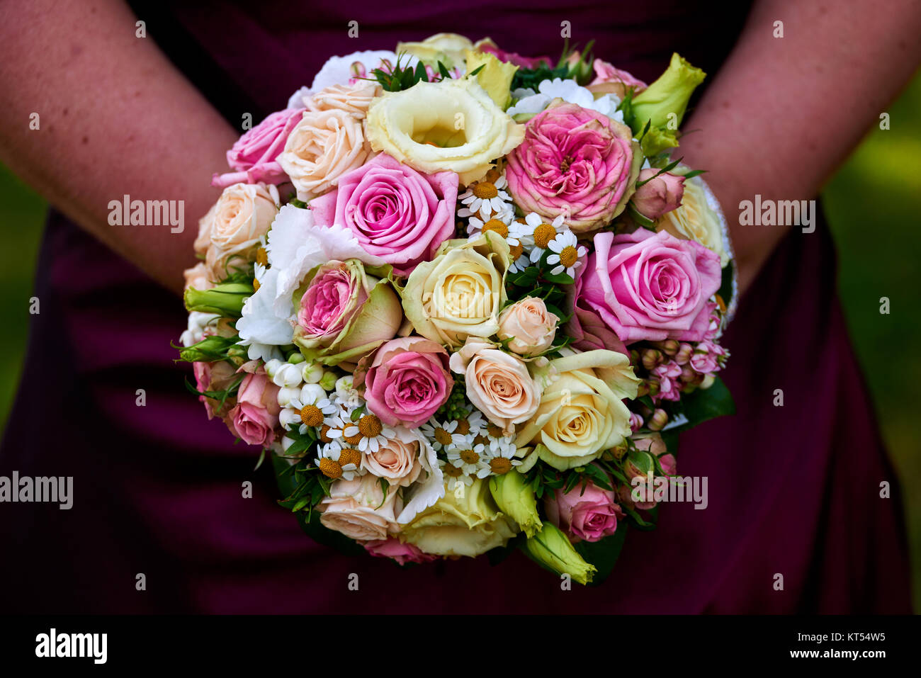 bride holding wedding bouquet with roses Stock Photo - Alamy