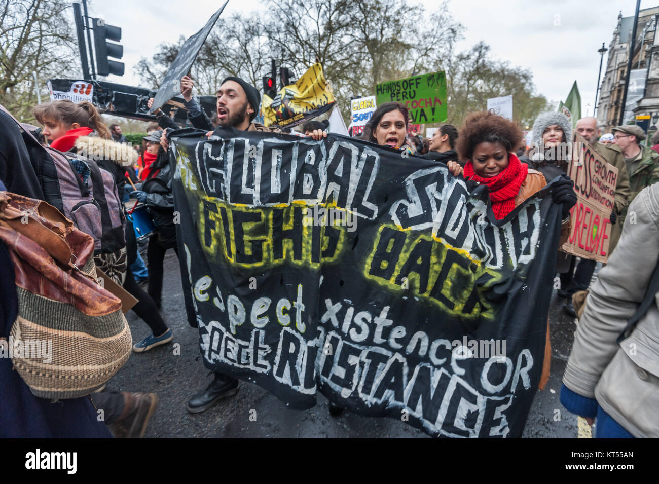 People in the Global Frontlines bloc leading the People's March for Climate & Jobs in London carry a banner 'Global South Fights Back - Respect Existence OR Expect Resistance'. Stock Photo