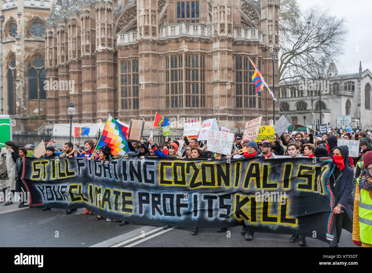 The Global Frontline bloc marches opposite Parliament past the end of Westminster Abbey on the People's March for Climate & Jobs in London. Stock Photo