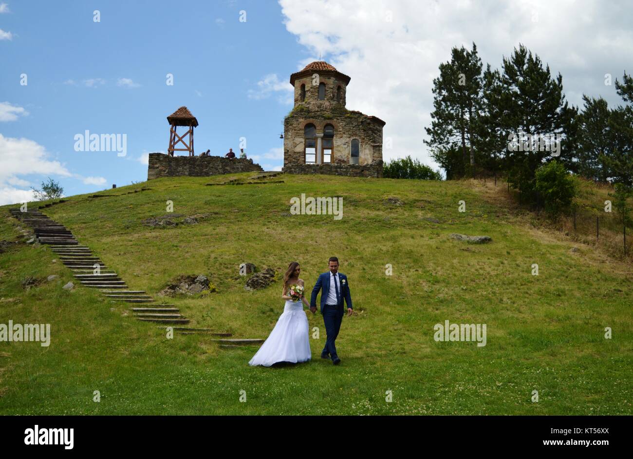 newlyweds next to the old church Stock Photo