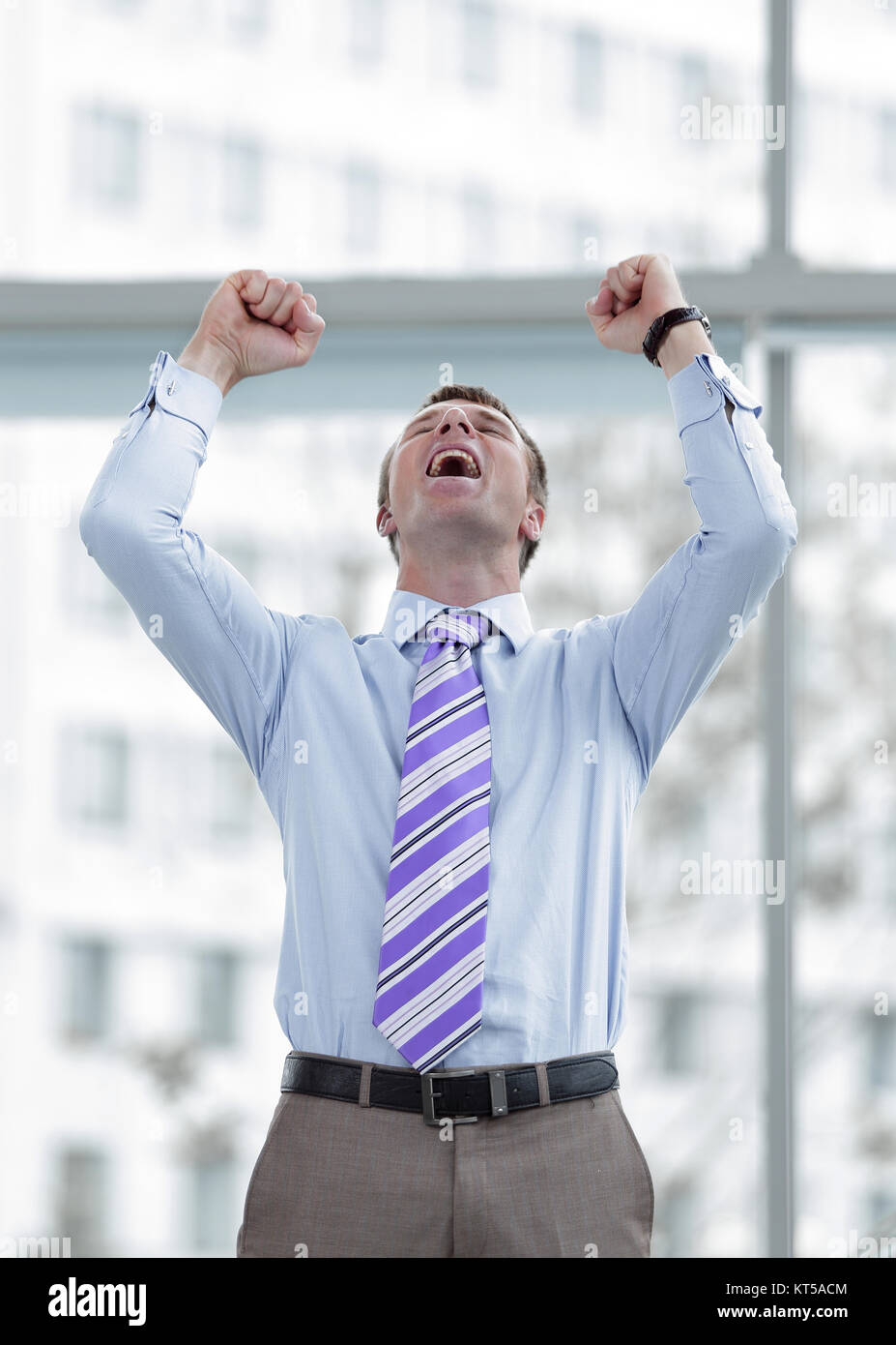Businessman celebrating with his fists raised in the air Stock Photo ...