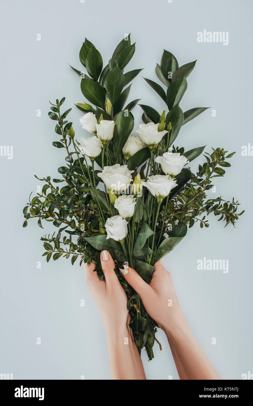 Cropped Image Of Female Hands Holding Bouquet With Eustoma Flowers