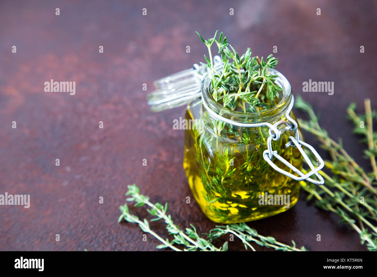 Thyme Oil Thyme Essential Oil Jar Glass Bottle And Branches Of Plant   Thyme Oil Thyme Essential Oil Jar Glass Bottle And Branches Of Plant KT5R6N 