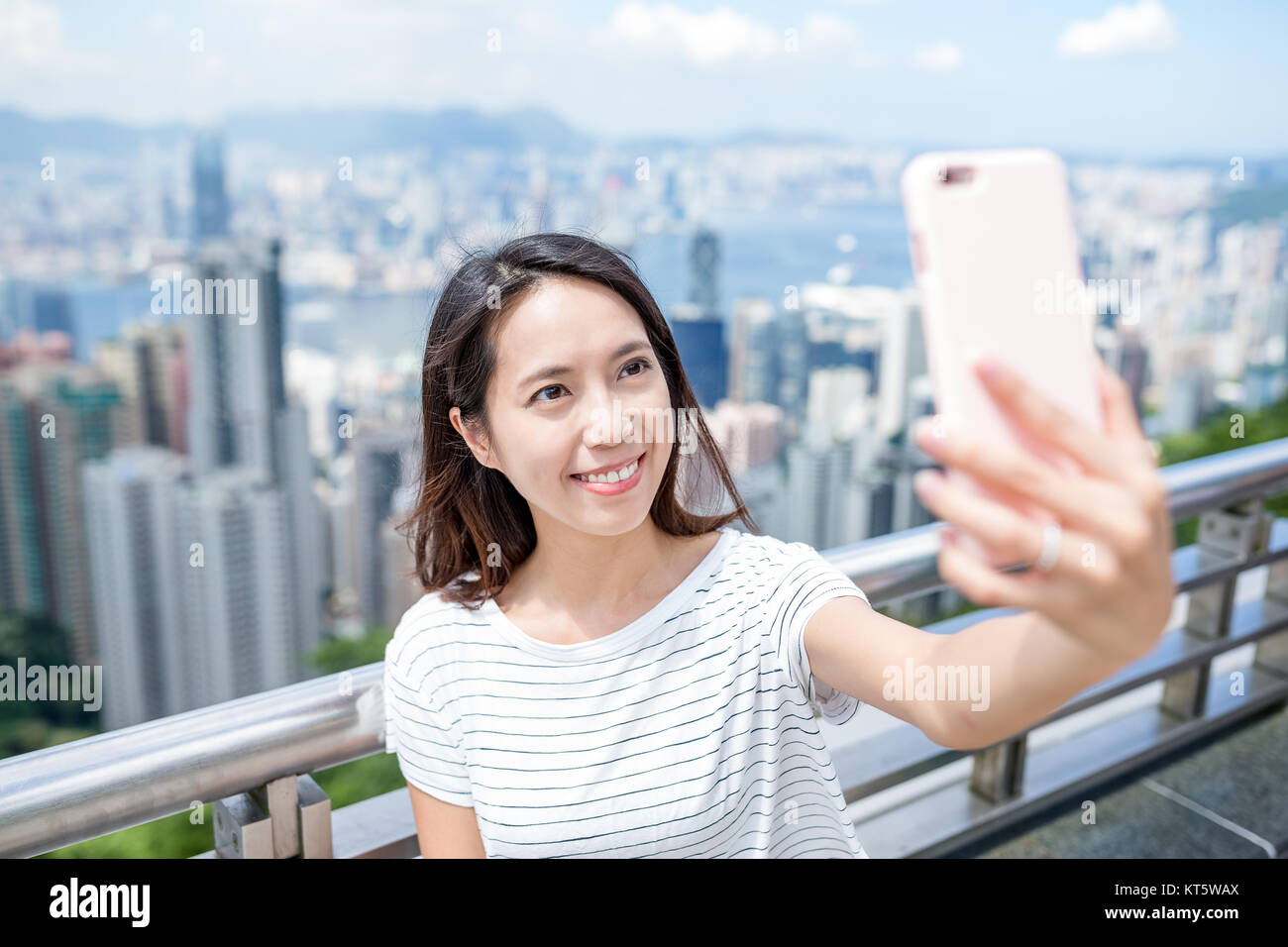 Woman taking selfie in Hong Kong Stock Photo - Alamy