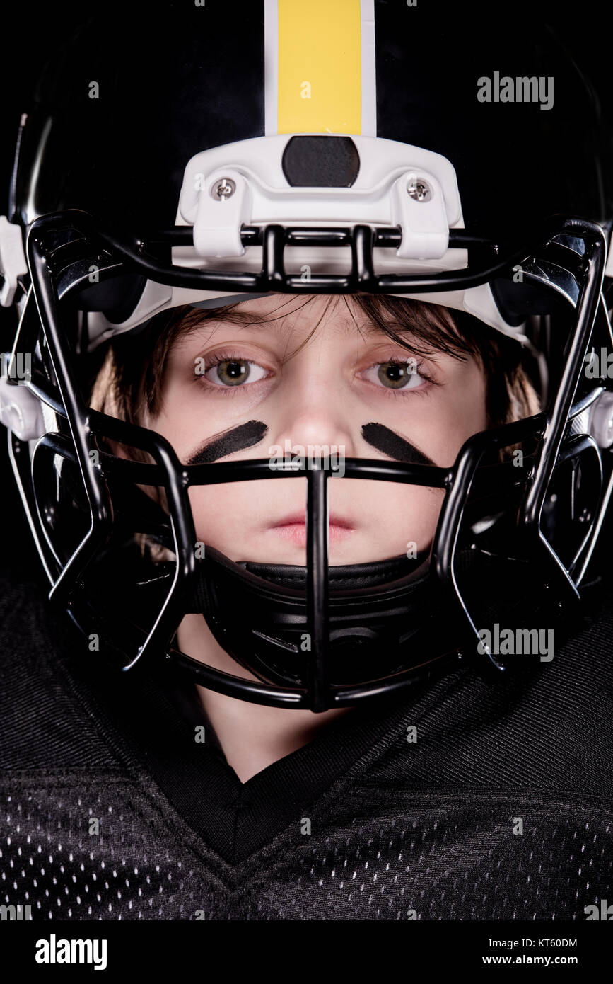 Close-up view of boy american football player in helmet looking at camera Stock Photo