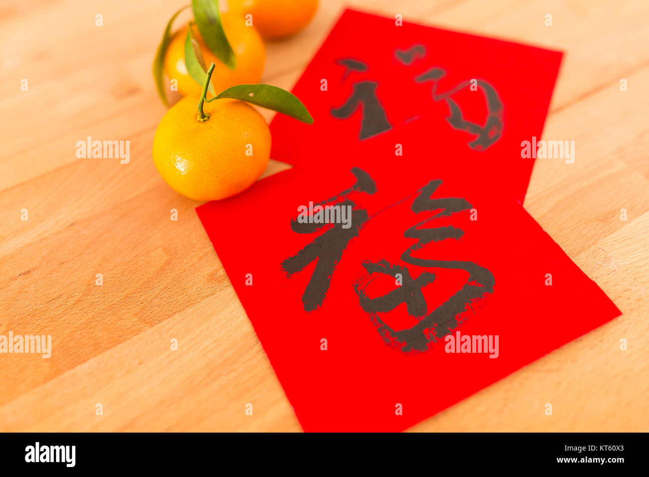 Chinese New Year Calligraphy with tangerine, words meaning lucky Stock