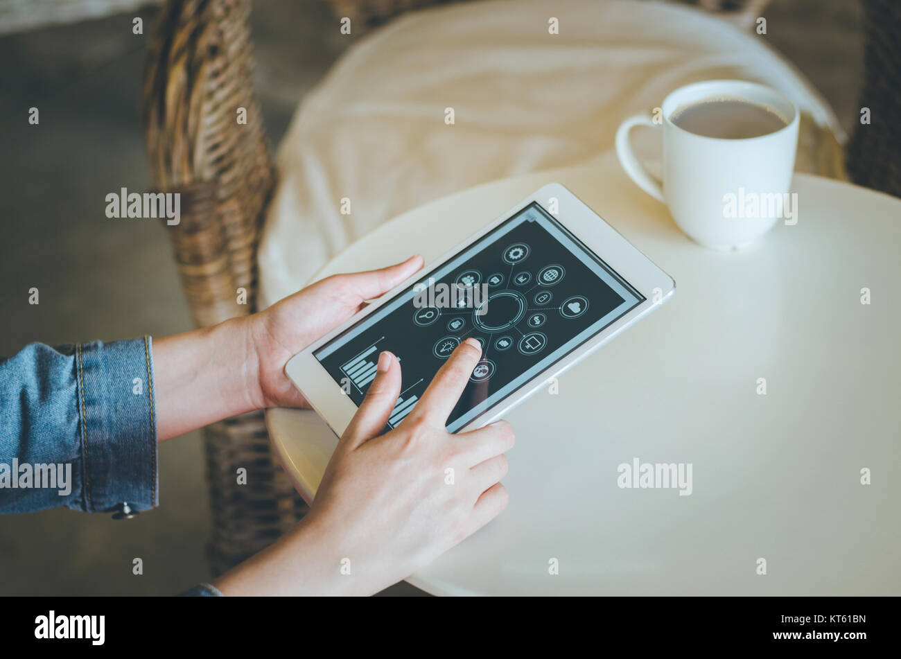 Close-up young woman using tablet with social icon screen in coffee shop. Stock Photo