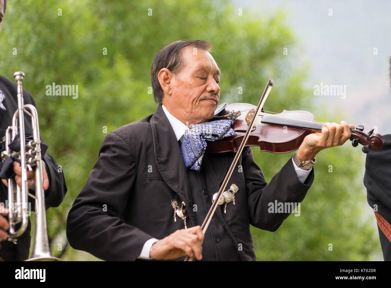 Mariachi violinist in deep concentration, playing outdoors Stock Photo