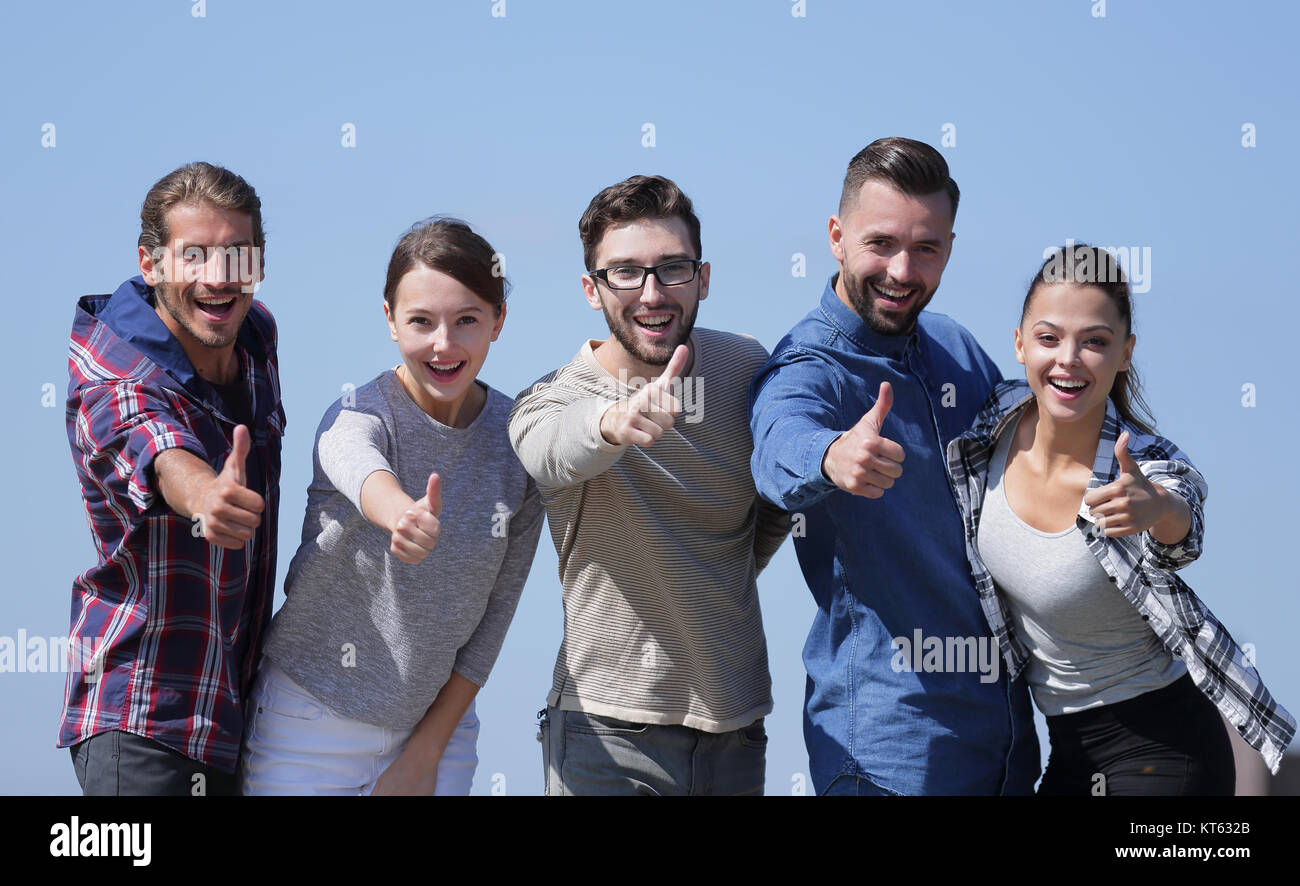 smiling group of young people showing thumb up Stock Photo - Alamy