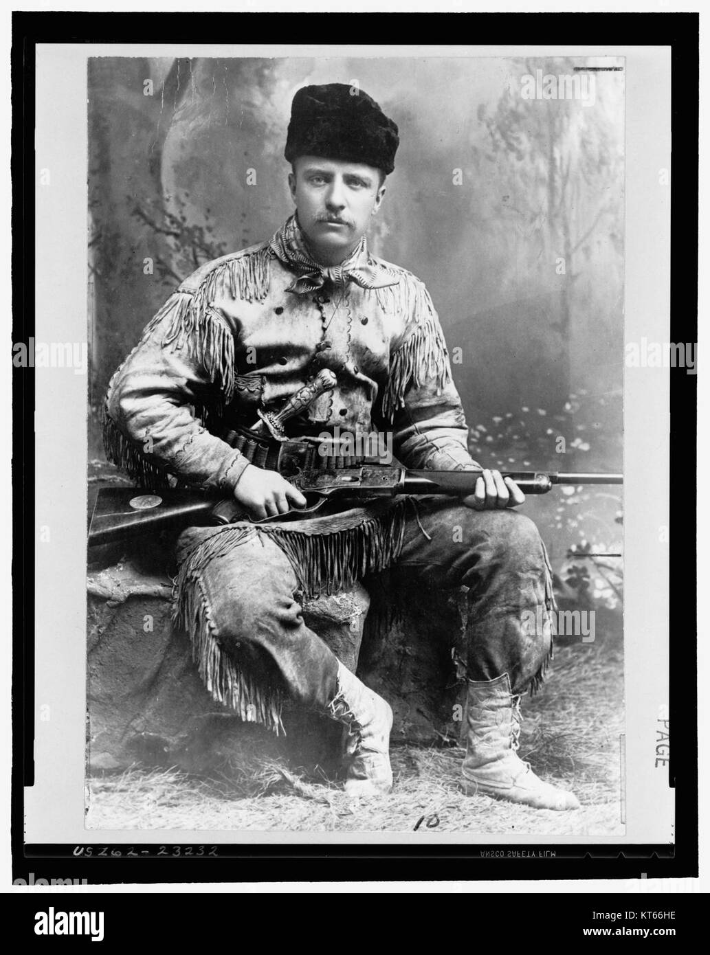This image shows Theodore Roosevelt in a hunting suit, holding a rifle, which is iconic of his adventurous spirit and interest in conservation and big-game hunting during his presidency. Stock Photo