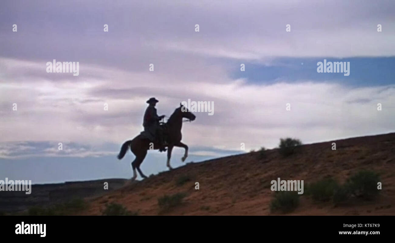 A screenshot from the trailer of 'The Searchers,' a 1956 American Western film directed by John Ford. The film features John Wayne as a Civil War veteran who embarks on a journey to rescue his niece from Native American captors. Stock Photo