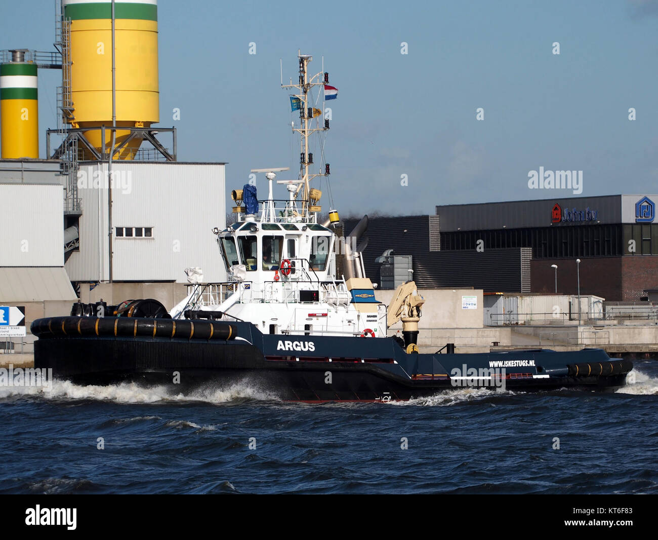 The 'Argus' is a tugboat identified by its IMO number 9600762, operating in the Noordzeekanaal and Port of Amsterdam. It plays a crucial role in port operations and maritime logistics. Stock Photo