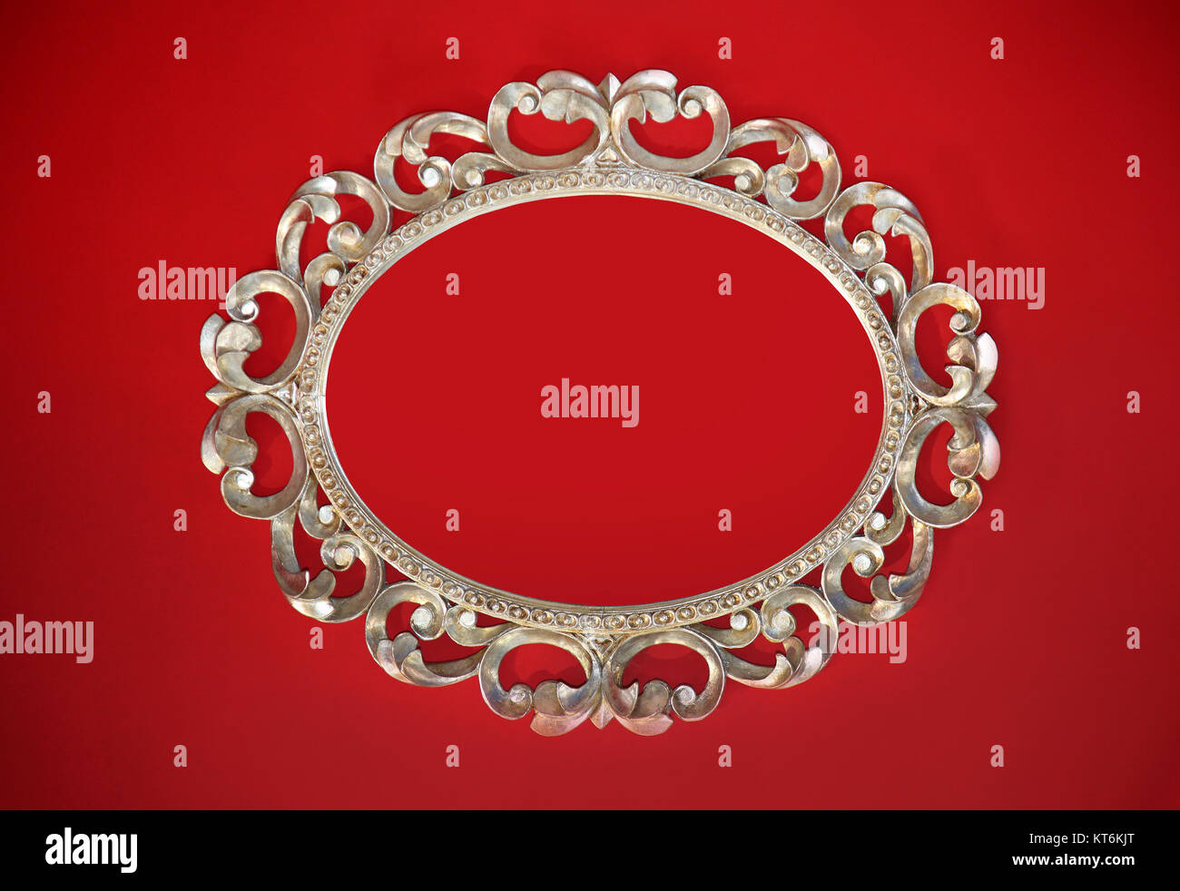 Vintage silver oval frame on red wall Stock Photo Alamy