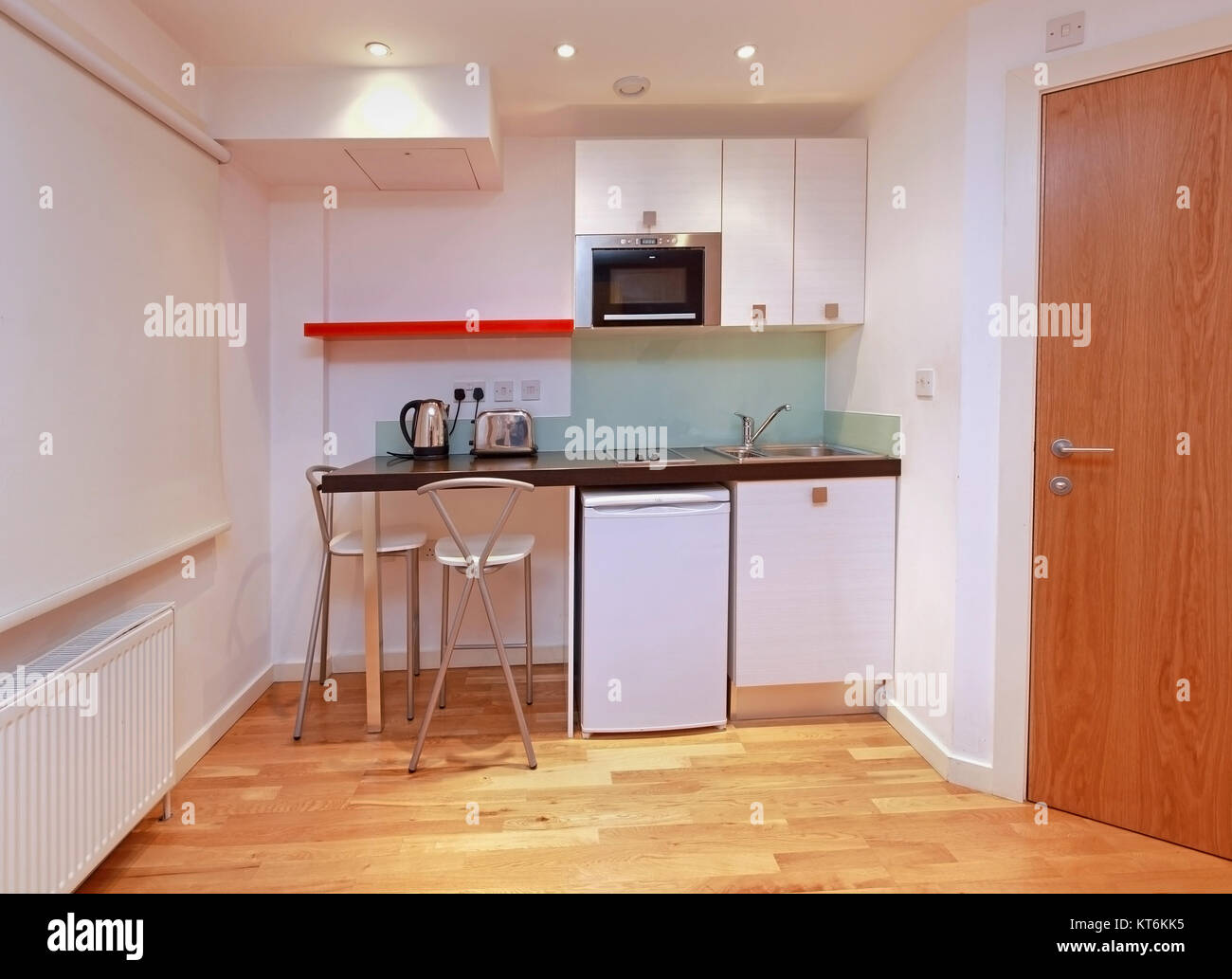 Small modern kitchen in tiny studio apartment Stock Photo