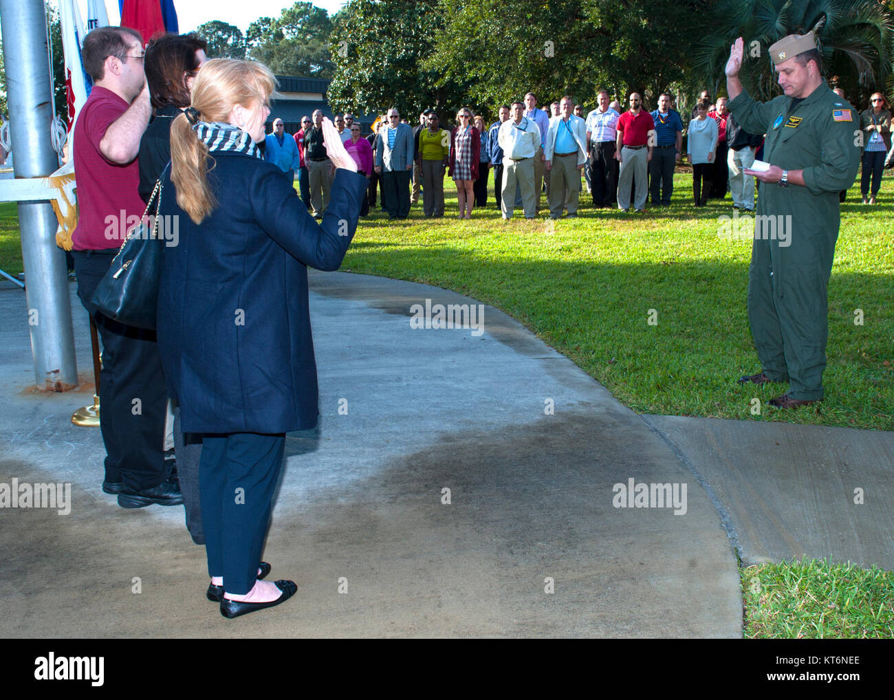 PANAMA CITY, Florida - Naval Surface Warfare Center Panama City Division Executive Officer recites administers the oath of office to a group of newly hired federal civil servants around the command flagpole at the Veterans Day Celebration Nov. 13, 2017. U.S. Navy Stock Photo
