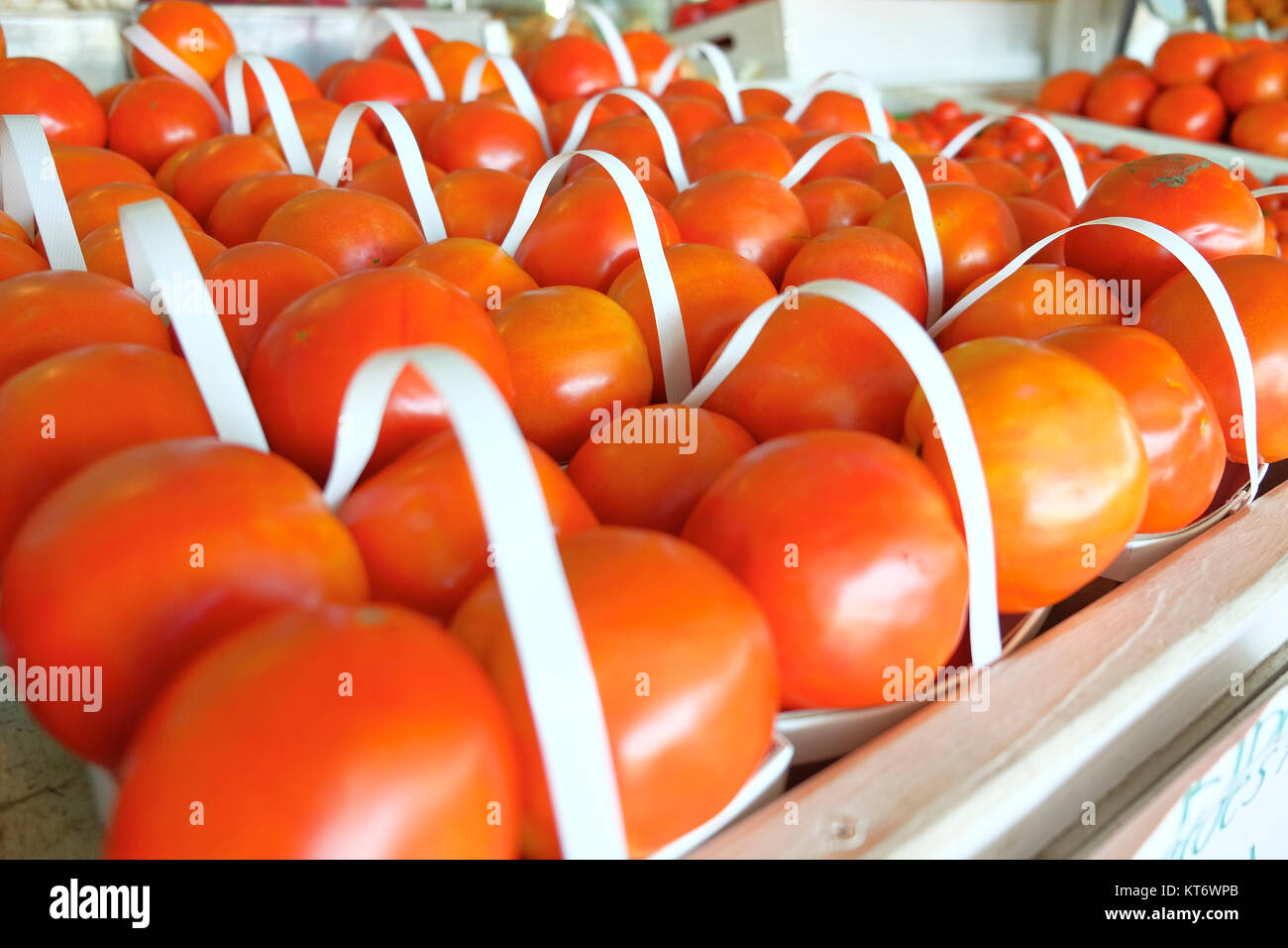 Close up of farm fresh beefsteak tomatoes in baskets at a farmer's market or produce market in rural Alabama, USA. Stock Photo