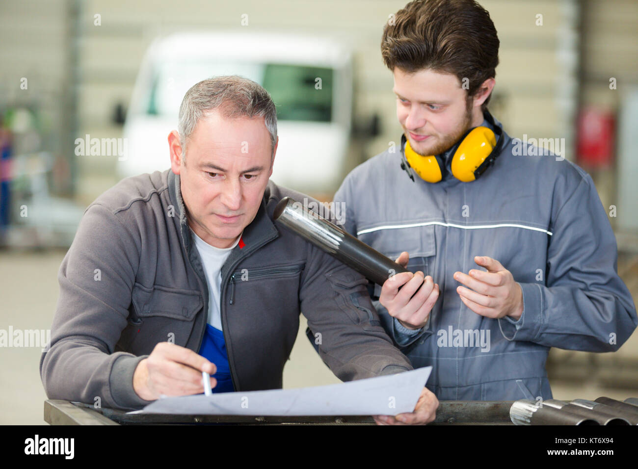 engineer and apprentice in factory Stock Photo - Alamy