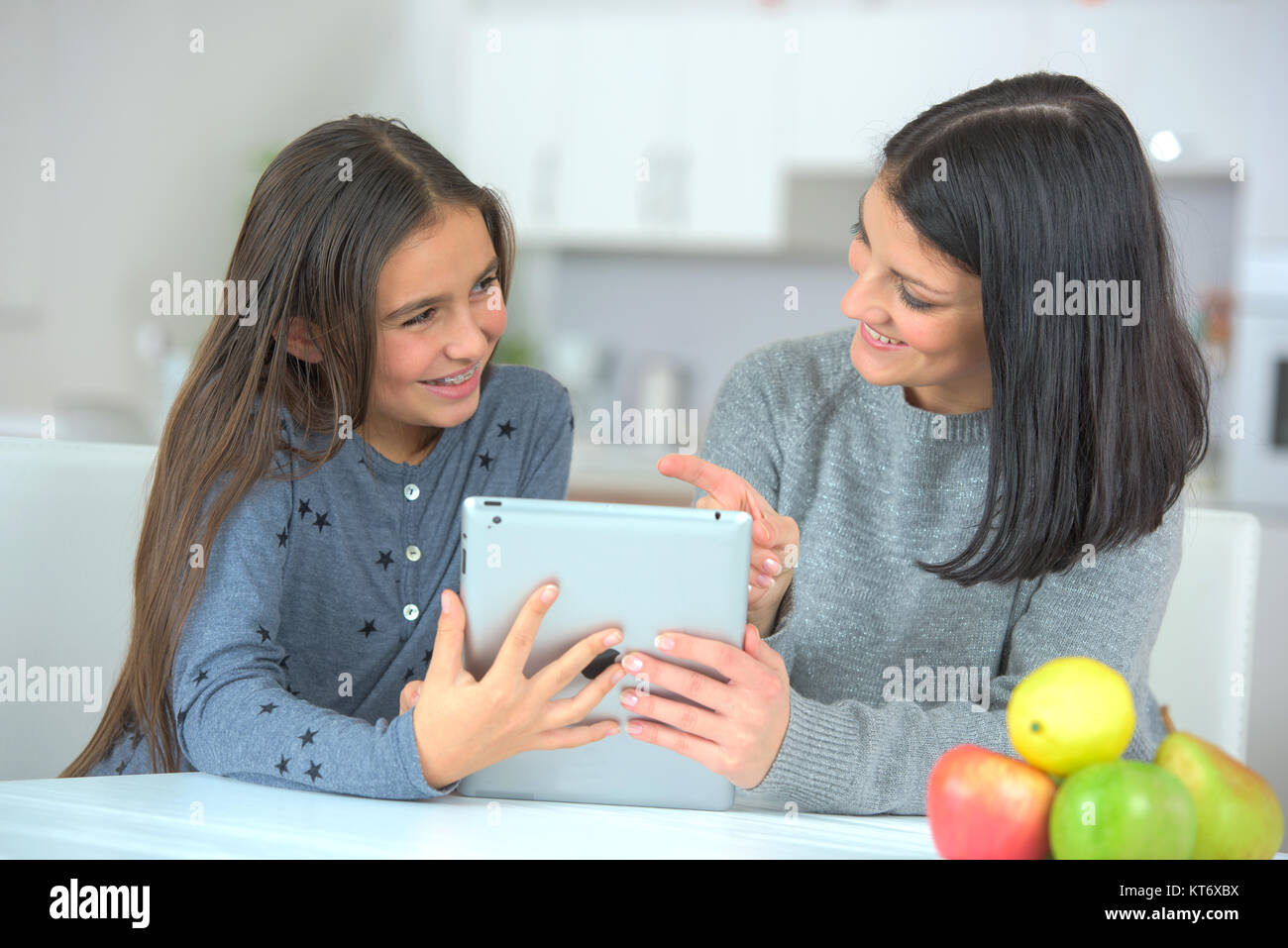 mother showing media content to daughter Stock Photo - Alamy