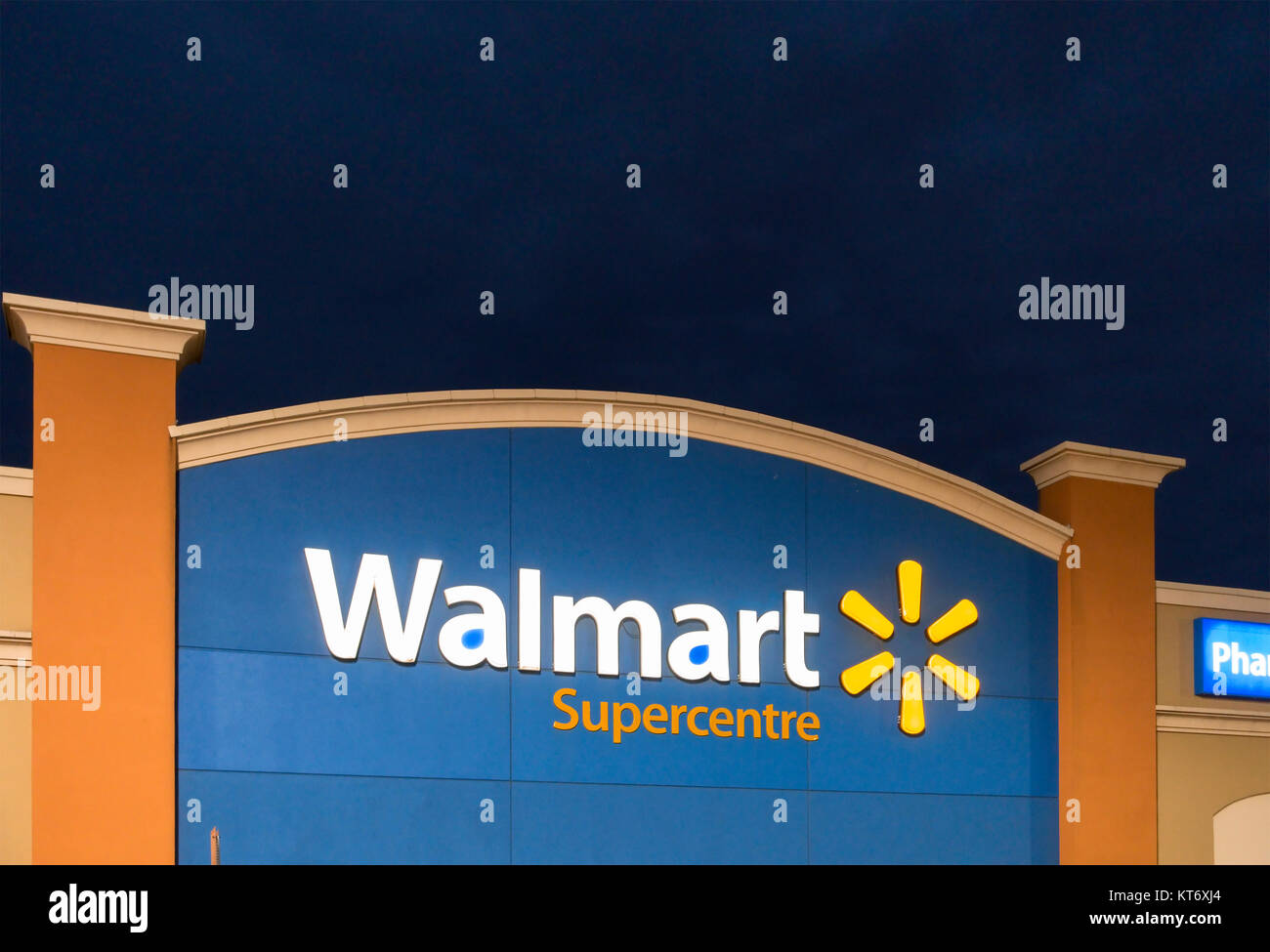 A Walmart Superstore logo or sign on the front of the store, owned and operated by Walmart Canada Corp. Stock Photo