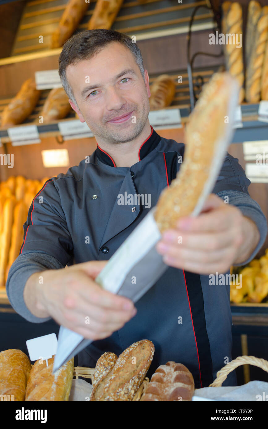 handling over the baguette Stock Photo