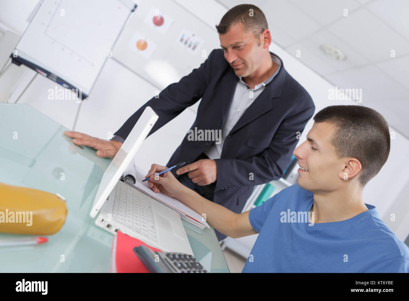 student and teacher working on computer in classroom Stock Photo - Alamy