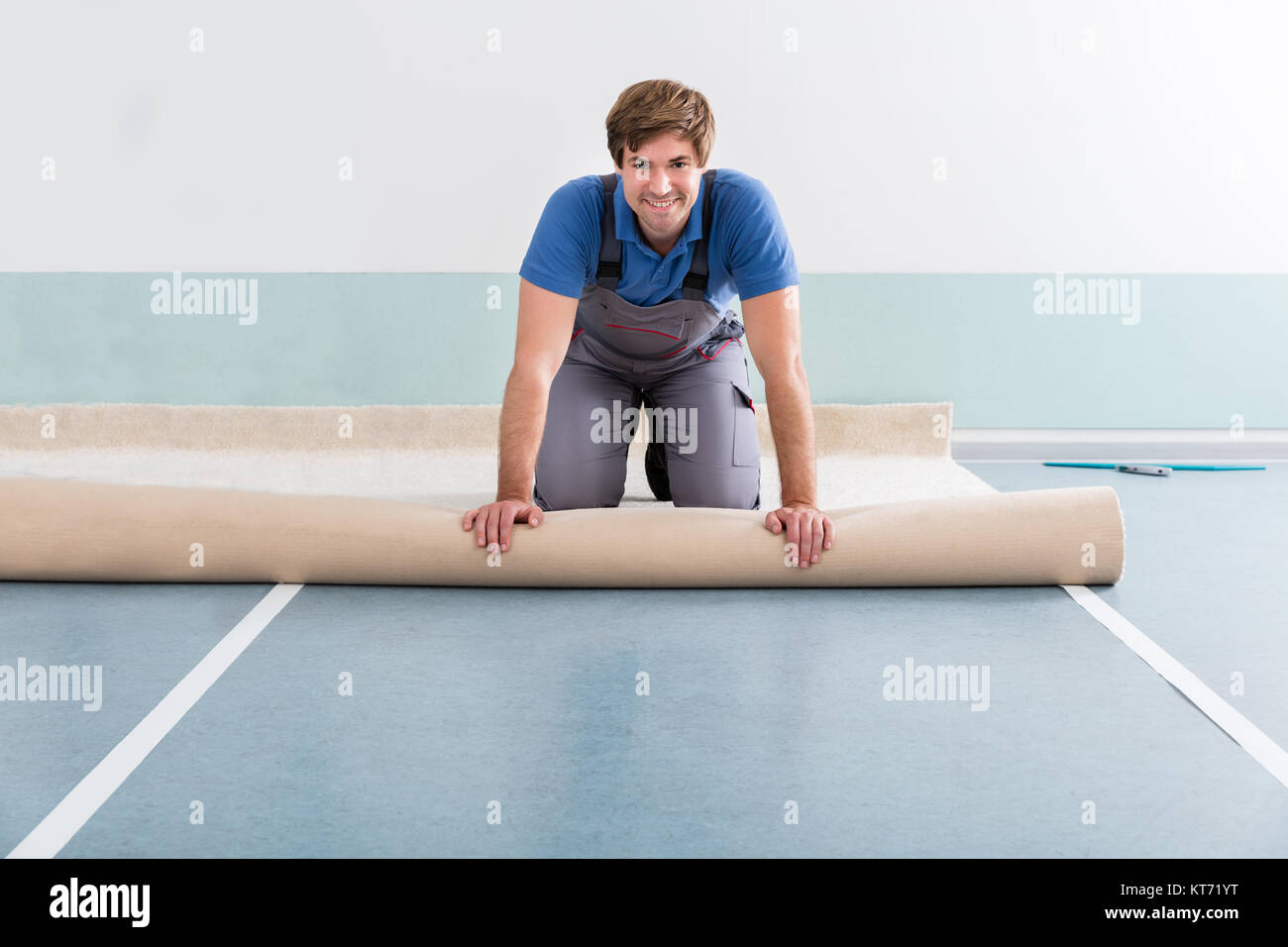 Young Man Laying Carpet Stock Photo - Alamy