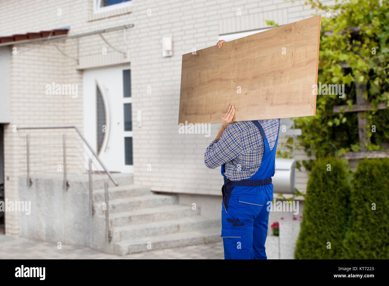 Mover Carrying Piece Of Furniture Stock Photo Alamy