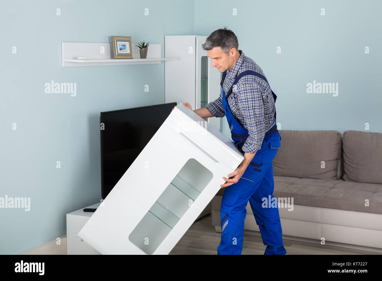 Mover Placing Furniture At Home Stock Photo Alamy
