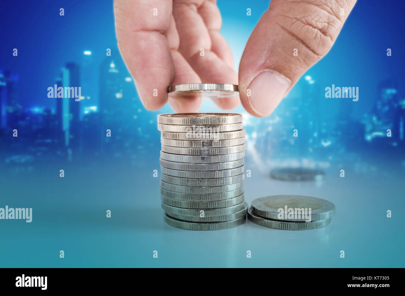 Saving money concept. hand putting coin to stacks of coins Stock Photo ...