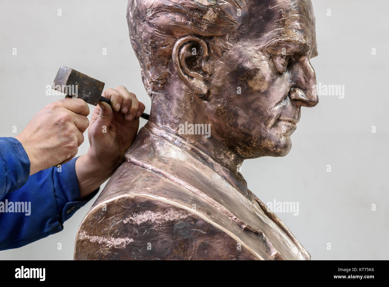 Sculptor working. Adding the finishing touches to the bust of a male figure Stock Photo Alamy