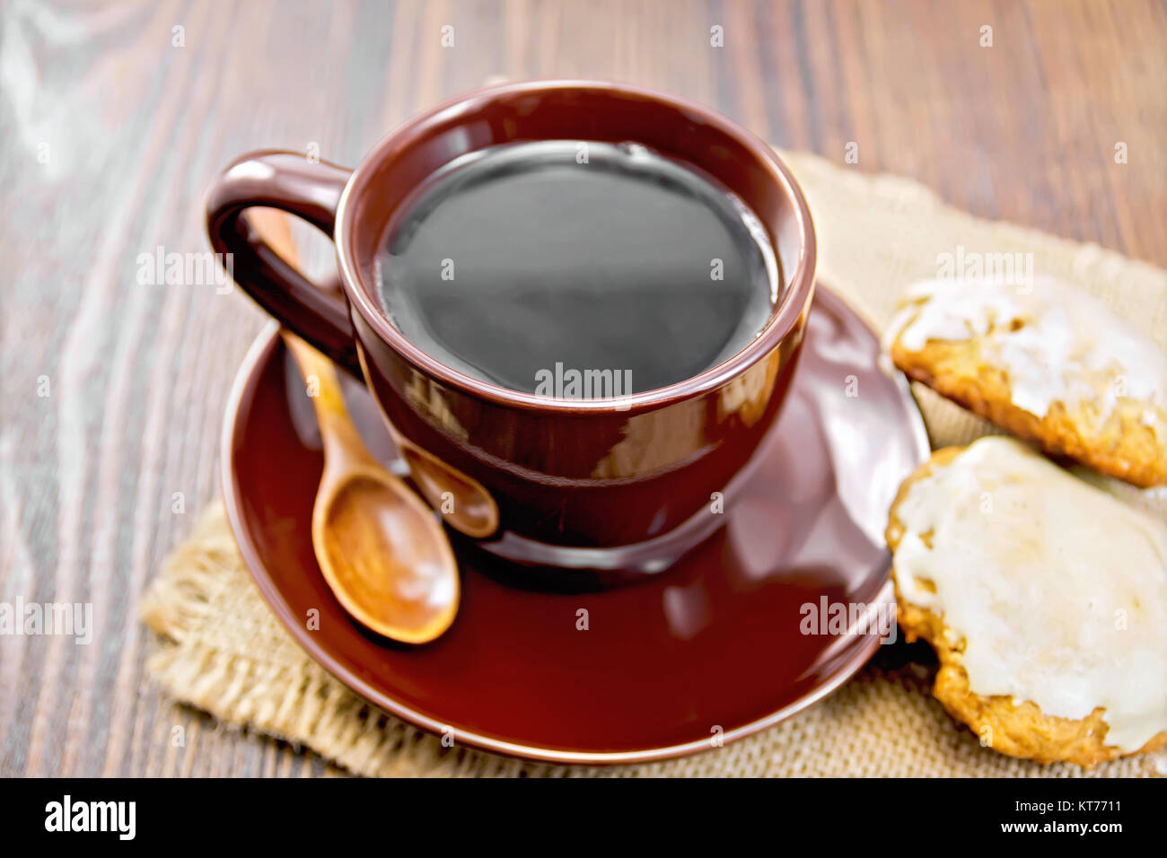 Coffee in brown cup with cookies on dark board Stock Photo