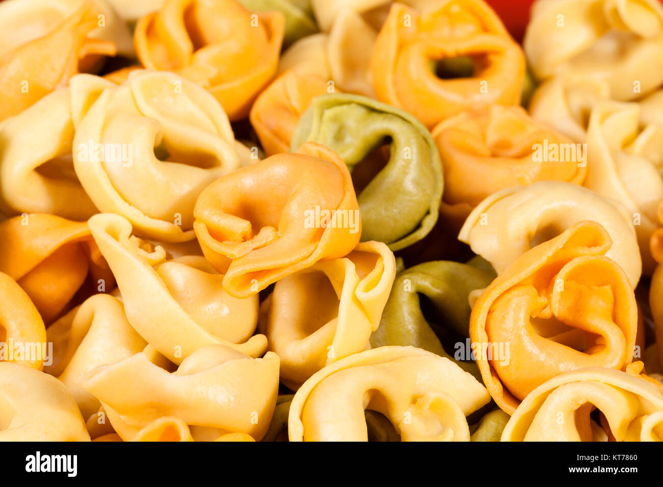 Background of colored tortellini, ring-shaped pasta Stock Photo