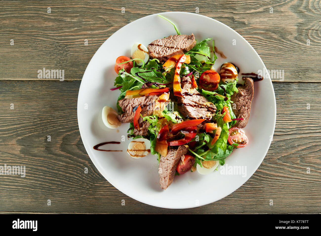 Close-up of delicios vegetable salad,including veal slices, quail eggs,cherry tomatoes. Tasty for restaurant meal with light red or white wine or cham Stock Photo