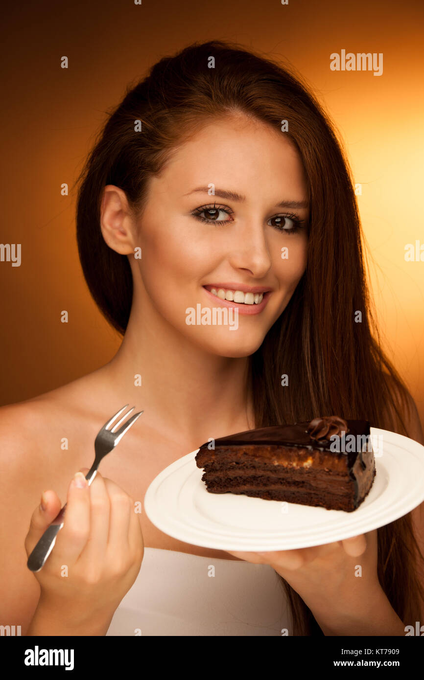 chocolate cake - glamorous woman eats dessert Stock Photo