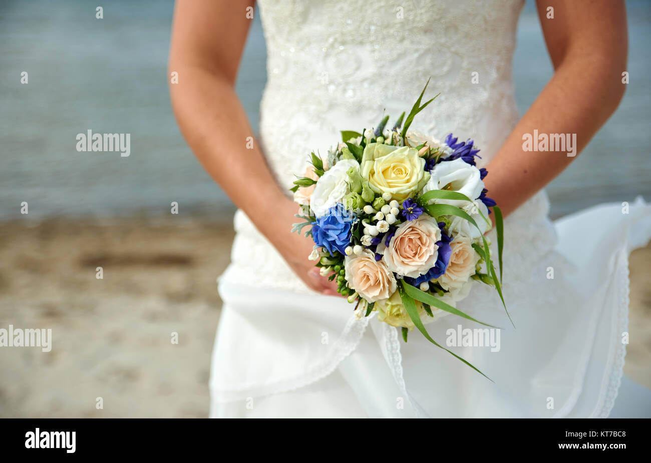 bride holding wedding bouquet with roses Stock Photo - Alamy