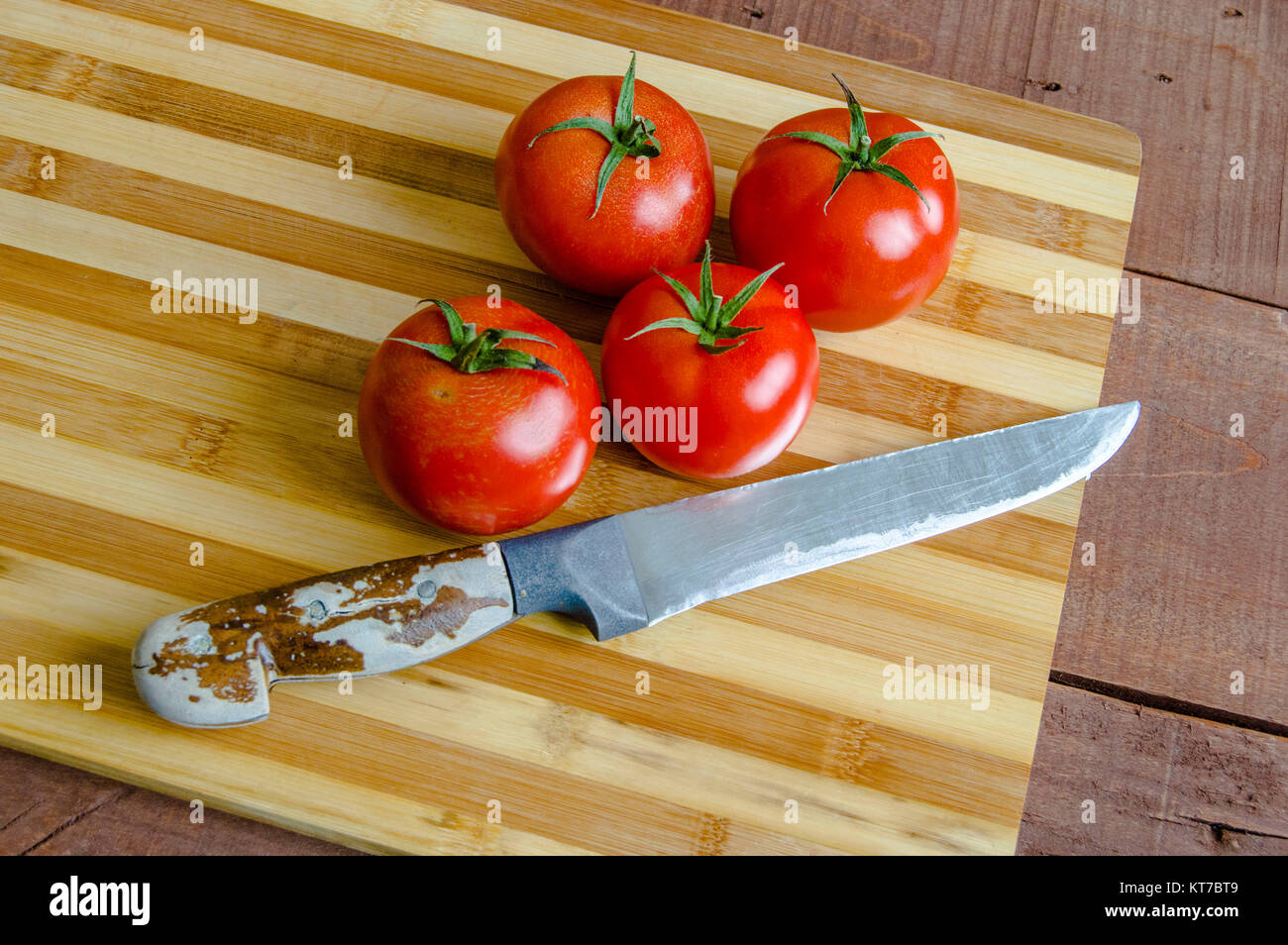 Tomatoes ready for salad, pictures of wonderful looking tomatoes Tomatoes on knife and chopping board Stock Photo