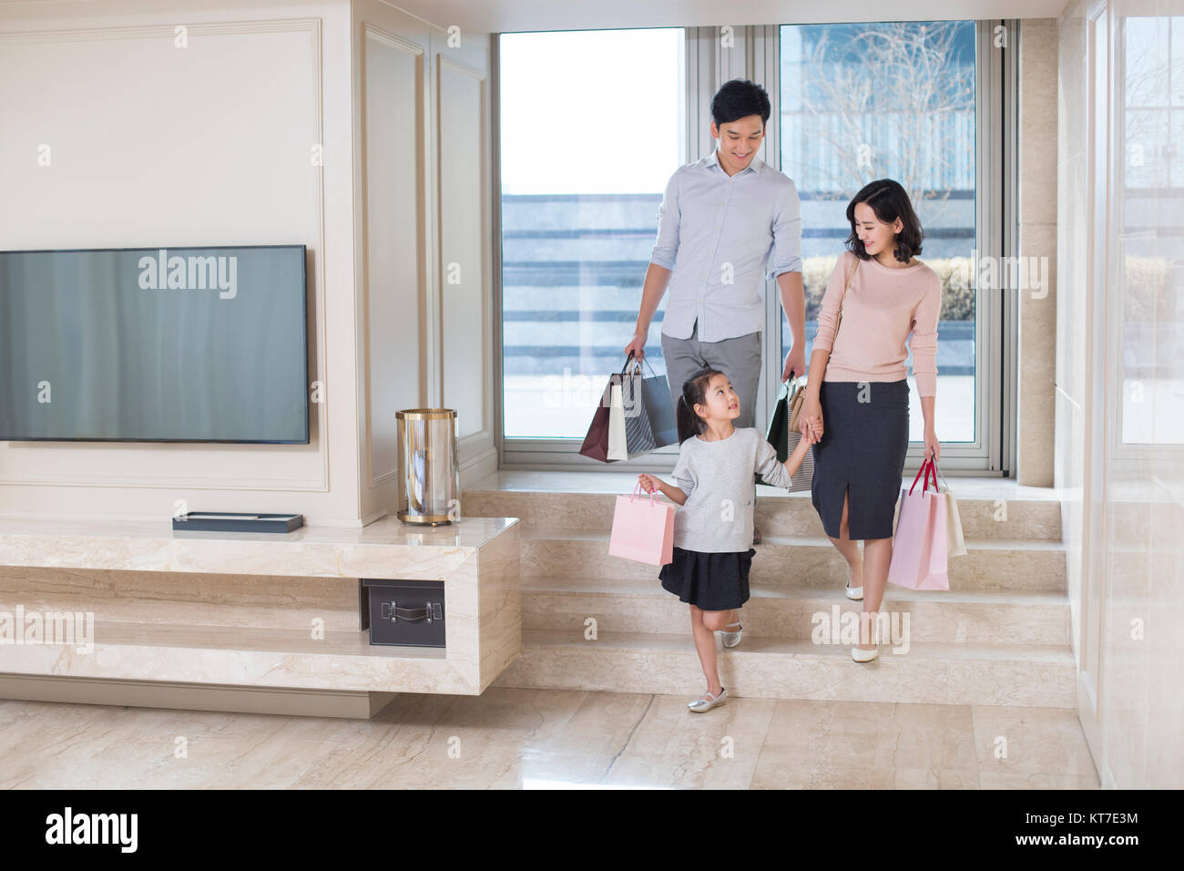 Young family coming back from shopping Stock Photo - Alamy