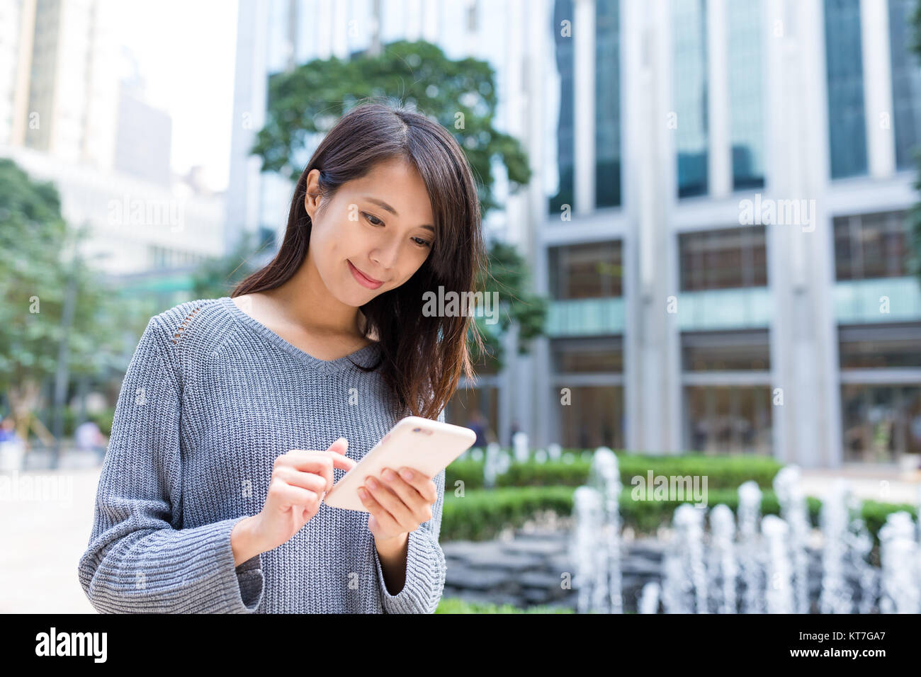 Woman using mobile phone at Hong Kong Stock Photo - Alamy