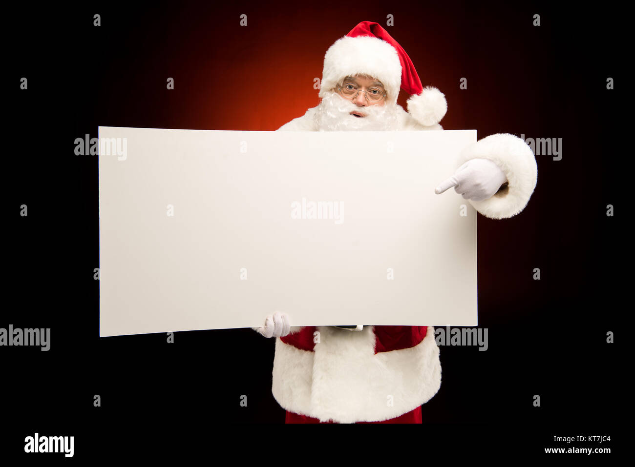 Santa Claus pointing on blank card Stock Photo - Alamy