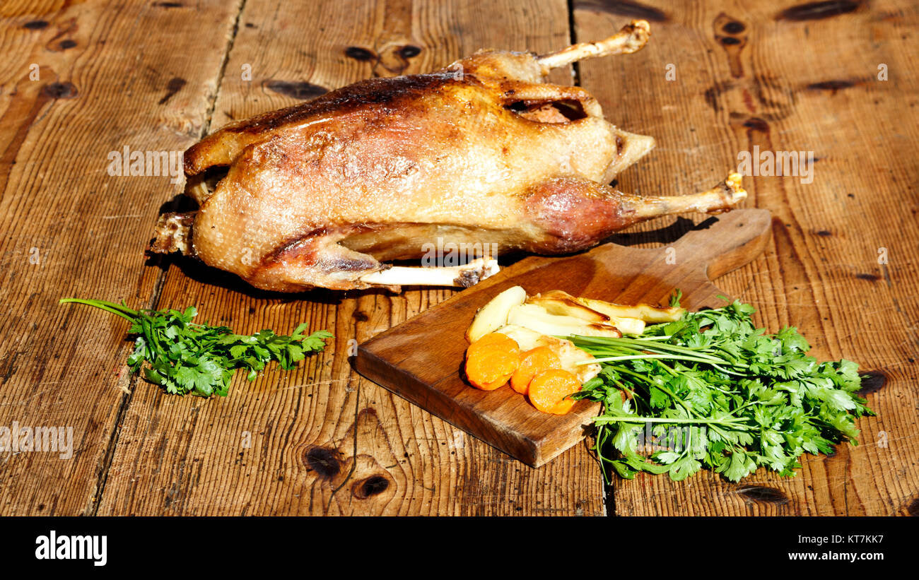 Roasted goose on wooden table Stock Photo
