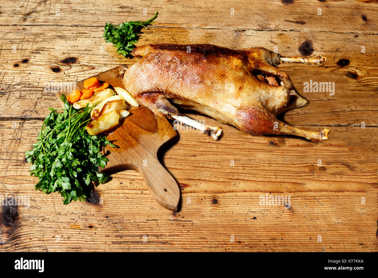 Roasted goose on wooden table Stock Photo