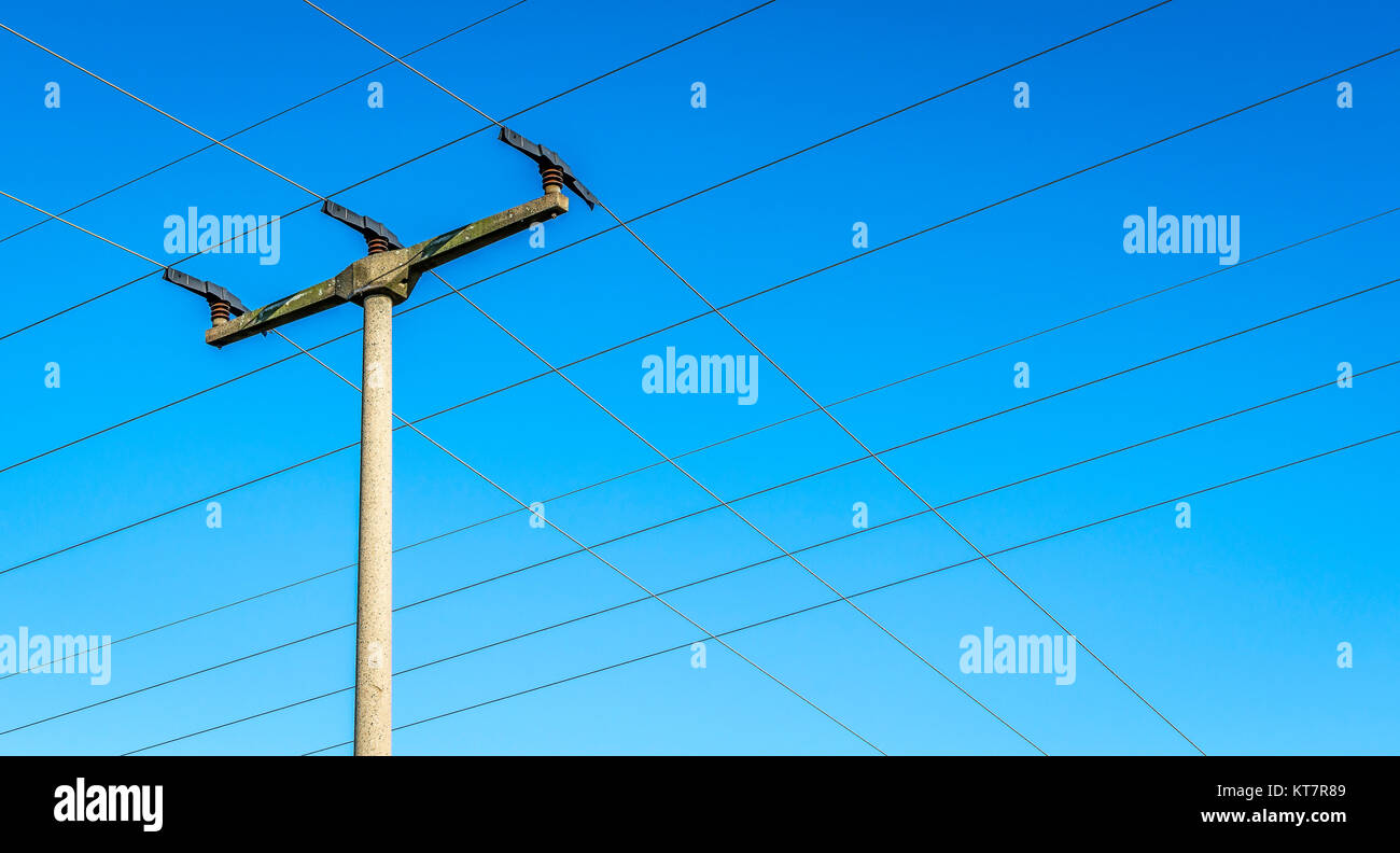 electricity pylon and many power lines in front of blue sky Stock Photo ...