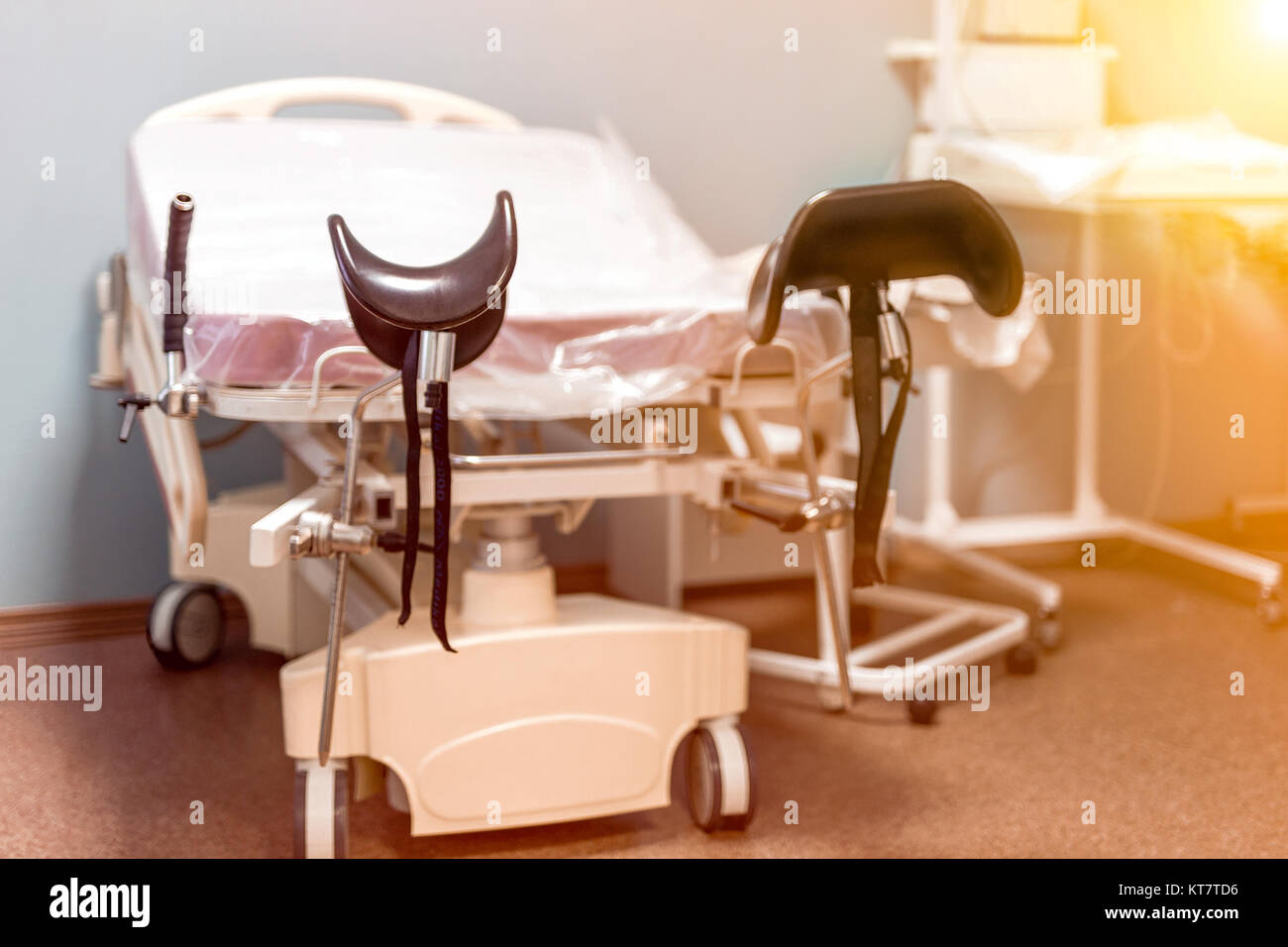 Empty delivery room with bed and medical equipment  in the maternity ward at a hospital. Stock Photo