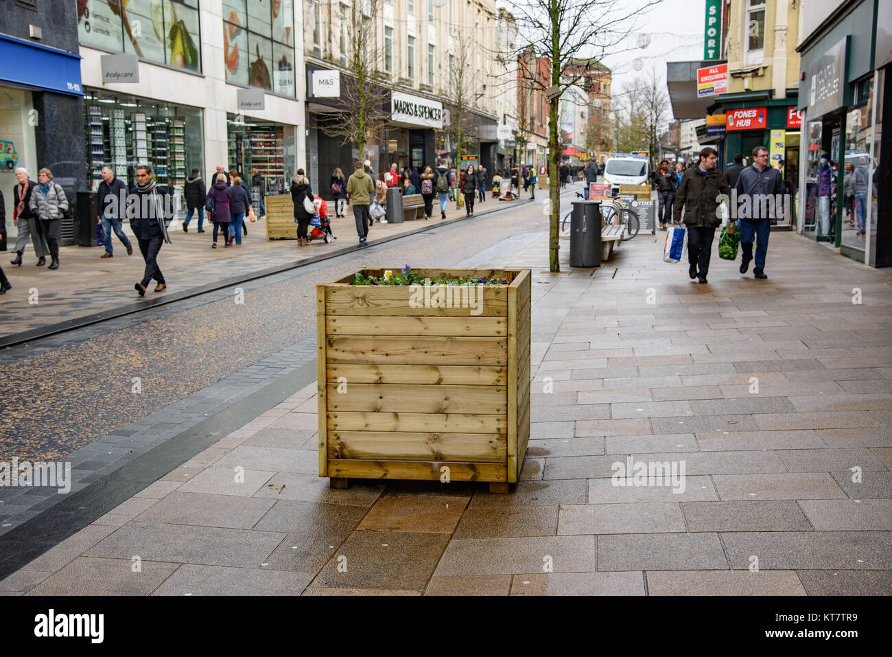 Wooden boxes planted with flowers used as protection against a terrorist attack by a vehicle down the pedestrian area, Fishergate, Preston, Lancashire Stock Photo