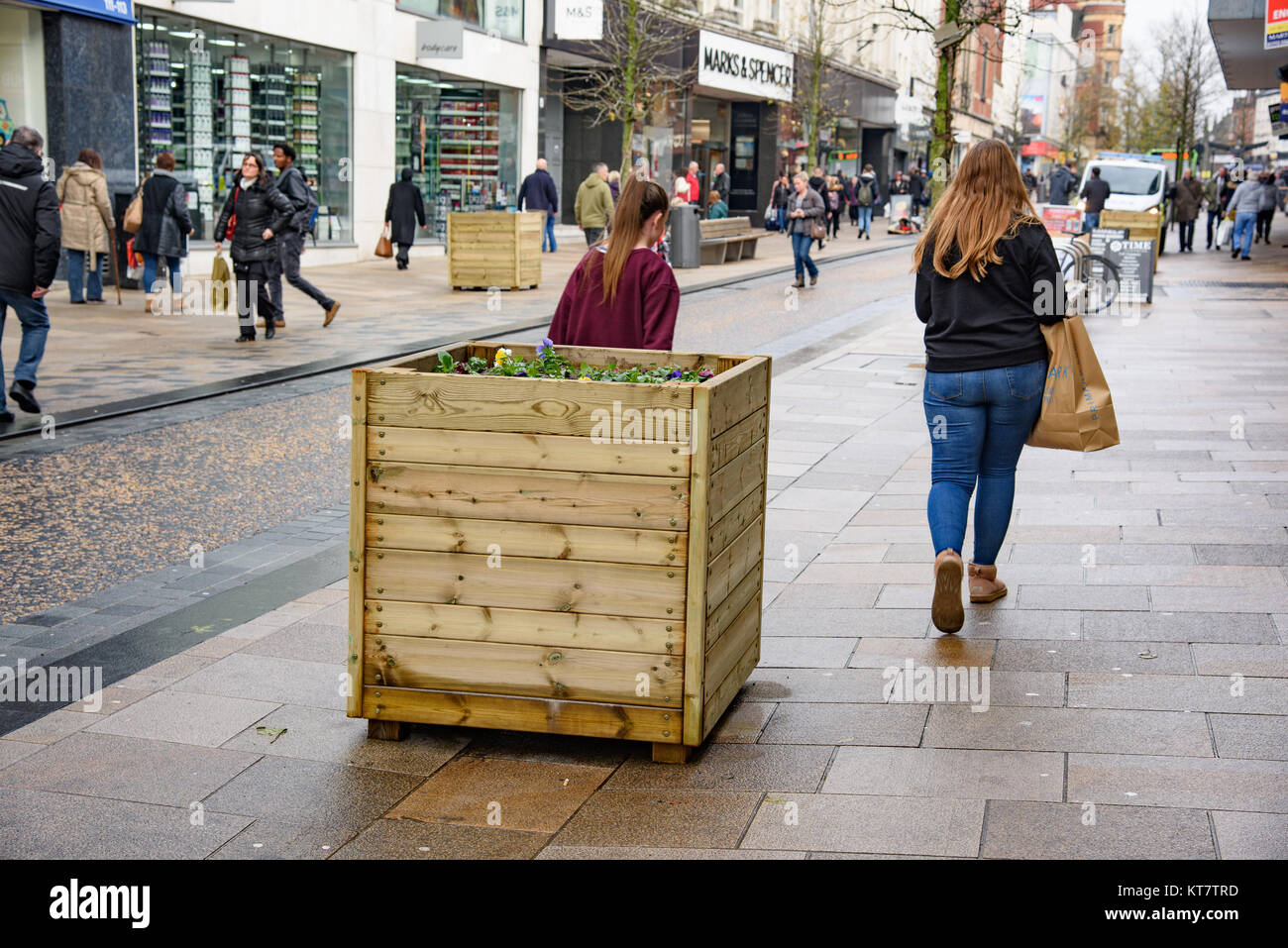 Wooden boxes planted with flowers used as protection against a terrorist attack by a vehicle down the pedestrian area, Fishergate, Preston, Lancashire Stock Photo