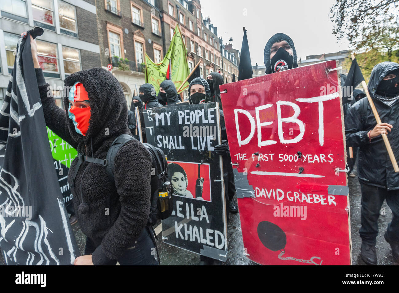 Some of the black bloc marchers on the NCAFC Student march for free education - No Barriers, No Borders, No Business carried 'Book Bloc' posters of various left classics. Stock Photo