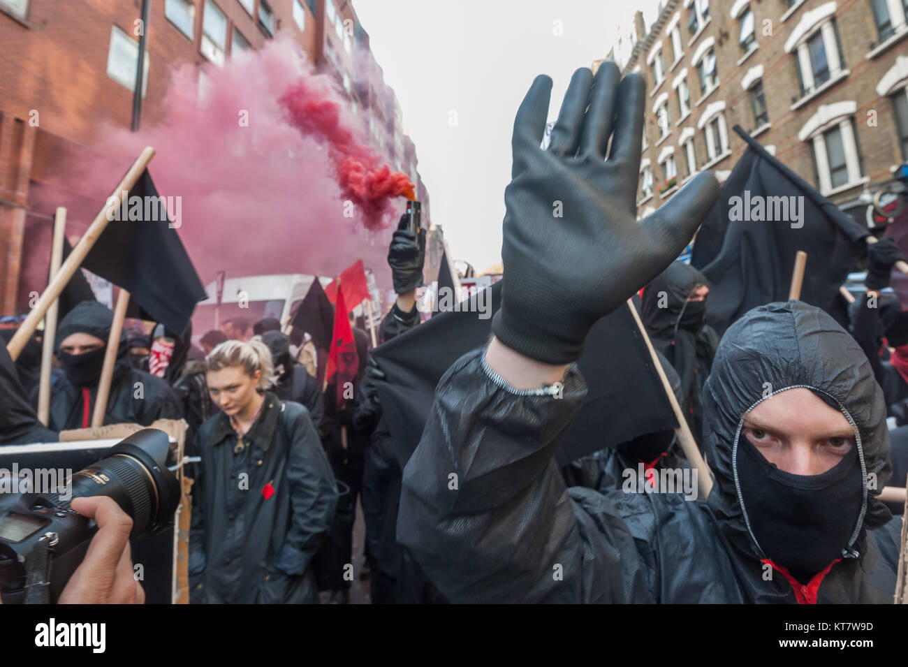 Black bloc students let of several smoke flares on the NCAFC Student march for free education - No Barriers, No Borders, No Business. Stock Photo