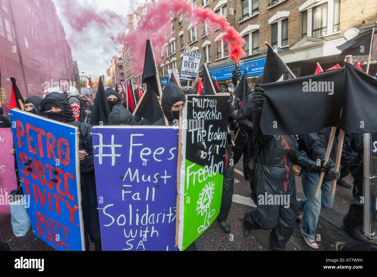 Black bloc students who were led by a 'Book bloc'  let of several smoke flares on the NCAFC Student march for free education - No Barriers, No Borders, No Business. Stock Photo
